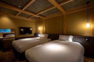 Postel nebo postele na pokoji v ubytování Hotel Utano Kyoto Besho