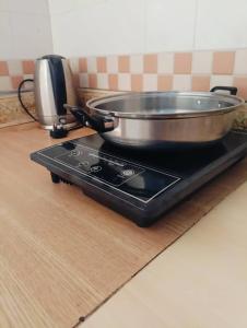 a pan sitting on top of a stove in a kitchen at ZNZ Oasis Homestay in Port Dickson +8 photos