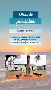 a book with a picture of a monument in the water at Pousada Ancoradouro in Cananéia
