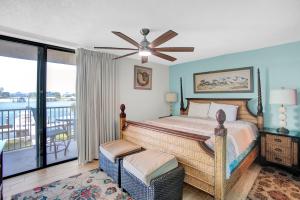 a bedroom with a bed and a balcony at Wind Drift 114 North by Vacation Homes Collection in Orange Beach