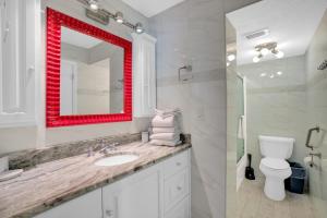 a bathroom with a sink and a red mirror at Wind Drift 114 North by Vacation Homes Collection in Orange Beach