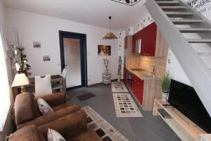 ein Wohnzimmer mit einem Sofa und einer Küche in der Unterkunft Sandpiper in Ypern