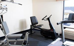 a room with a gym with a treadmill and chairs at Country Hearth Inn-Union City in Union City