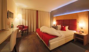 A bed or beds in a room at Waidringer Hof 4 Sterne Superior
