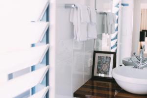 a bathroom with a sink and a toilet and towels at Oceandeck House in Ulladulla +30 photos