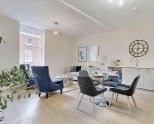 a living room with blue chairs and a table at The Byron Suite in Lichfield +10 photos