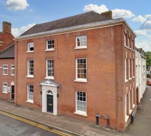an old brick building on a city street at The Byron Suite in Lichfield