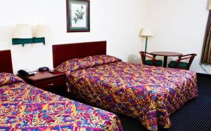 a hotel room with two beds and two night stands at Country Hearth Inn-Union City in Union City