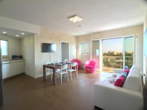 a living room with a couch and a table at GozoWindmill Apartments in Qala