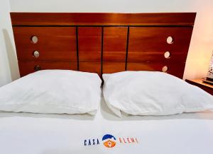 two white pillows sitting on top of a bed at Habitación Céntrica en Iquitos - Casa Alemi 6 in Iquitos