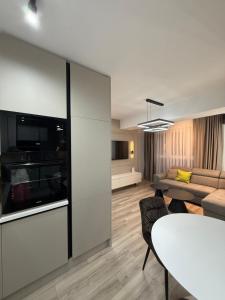 una sala de estar con un sofá y una mesa en New Modern One bedroom Apartment Julija, en Skopje