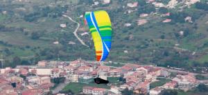 a kite flying in the air over a city at Casa Vacanze Karol in Trappeto