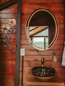 a bathroom with a sink and a mirror on the wall at La Finca De Frida in Guatapé
