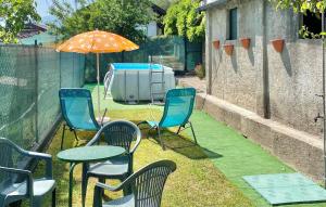 a patio with chairs and a table and an umbrella at Casetta Dei Lupi in Miazzina