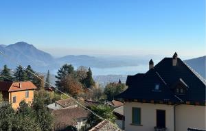 a view of a town with mountains in the background at Casetta Dei Lupi in Miazzina