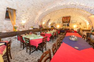 a dining room with red tables and chairs in a building at Il Fortilizio in Pietrelcina