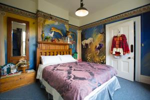 una camera da letto con un letto con copriletto viola di Merrybrook Studio a Oamaru