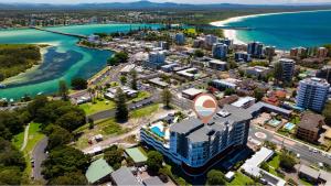 an aerial view of a city next to a body of water at Serenity at Solaris 101 in Forster