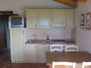 a kitchen with white cabinets and a sink and a microwave at Tenuta Lio Maggiore in Lido di Jesolo +37 photos