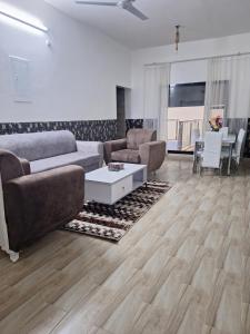 a living room with a couch and a table at Al Falak Chalet in Al Raka +1 photo