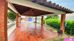 a brick patio with awning on a building at Apartamento San Gil Amoblado in San Gil