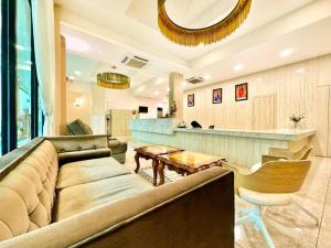 a living room with a couch and a bar at Well Hotel by UHA in Johor Bahru