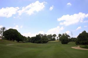 a view of a golf course with trees and a field at Well Hotel by UHA in Johor Bahru