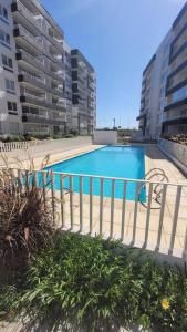 a swimming pool in front of some tall buildings at Acogedor Departamento la Serena 3D 2B wifi estacionamiento céntrico in La Serena