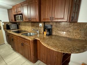 a kitchen with a sink and a counter top at Beach Escape private studio in Sunny Isles Beach