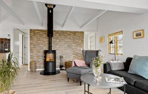 a living room with a wood stove in a room at Holiday Home Hejsager Strandby Haderslev Iv in Kelstrup Strand