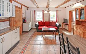 a living room with a red couch and a table at Ferienwohnung Südmüritz in Vipperow