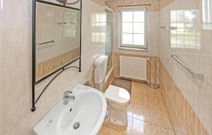 a bathroom with a sink and a toilet and a shower at Ferienwohnung Südmüritz in Vipperow +12 photos