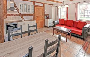 a living room with a red couch and a table at Ferienwohnung Südmüritz in Vipperow