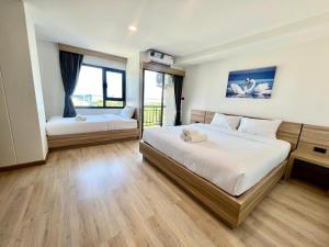 Postel nebo postele na pokoji v ubytování เวลโกรว์ โฮเทล - Wellgrow Hotel