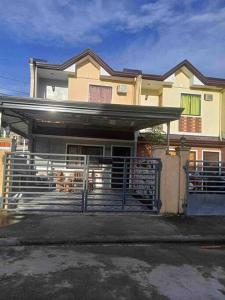 a house with a gate in front of it at Conveniently 3 Bedroom Cozy Cozy Corner Townhouse Near Robinson Mall, Butuan Doctors Hospital and Airport in Butuan