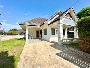 a white house with a pathway leading to it at Cozy 3 BR house & green lawn near Airport & Old town in Chiang Mai
