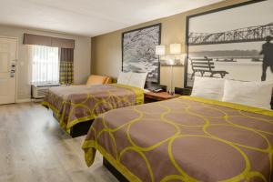 a hotel room with two beds and a bridge at Super 8 by Wyndham Knoxville West/Farragut in Knoxville +34 photos