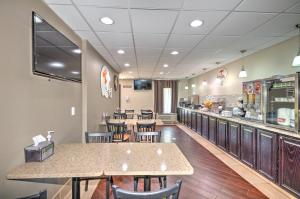 a restaurant with tables and chairs and a counter at Super 8 by Wyndham Knoxville West/Farragut in Knoxville