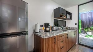 a kitchen with a sink and a counter top at Villa El Bosque Dorado in Fortuna