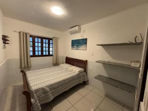 a small bedroom with a bed and a window at Casa Aconchegante Tamandaré in Tamandaré +44 photos