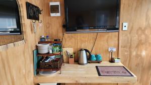 a wooden table with a television on top of it at Minimalist Cabin Solo Traveller in Ashburton