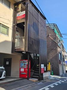 a building with a staircase on the side of it at YOYOGi STAY in Tokyo