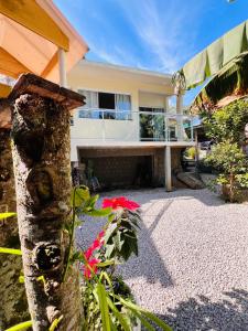 a house with a garden with flowers in front of it at Casa com banheira in Governador Celso Ramos