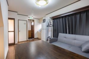 a living room with a white couch and a table at Mikazuki Ukima / MU1 in Tokyo