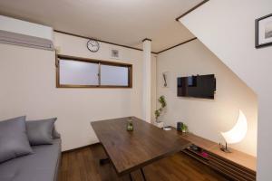 a living room with a couch and a table at Mikazuki Ukima / MU1 in Tokyo