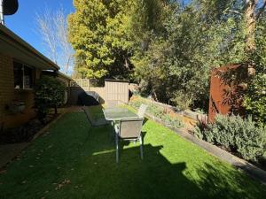 a table and chairs on the grass in a yard at Church St in Bright