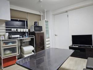 a kitchen with a glass table in a room at YOYOGi STAY in Tokyo +12 photos