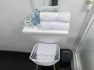 a bathroom with towels and a shelf with a basket at De Papel Homestay in Kota Bawah Timur +41 photos