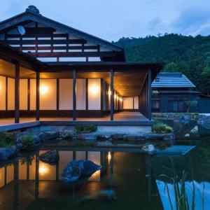 a house with a pond in front of it at Ryugon in Minami Uonuma