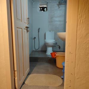 a bathroom with a toilet and a sink at Buransh Stays - Sari in Sari